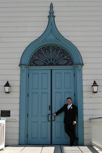 Half Moon Bay wedding - groom against blue door