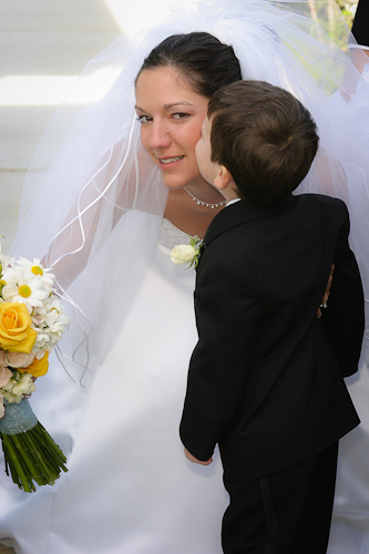 Half Moon Bay wedding - bride being kissed by little boy