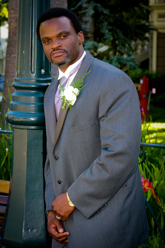 Preservation Park, Oakland wedding - groom against light pole