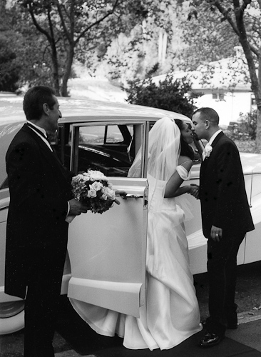 Mills College wedding photography - kissing in front of old car